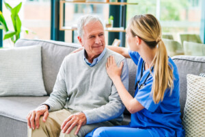 Shot of a young female doctor comforting a senior patient at a clinic